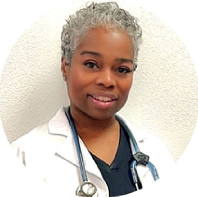 Smiling person in a lab coat with a stethoscope around their neck.