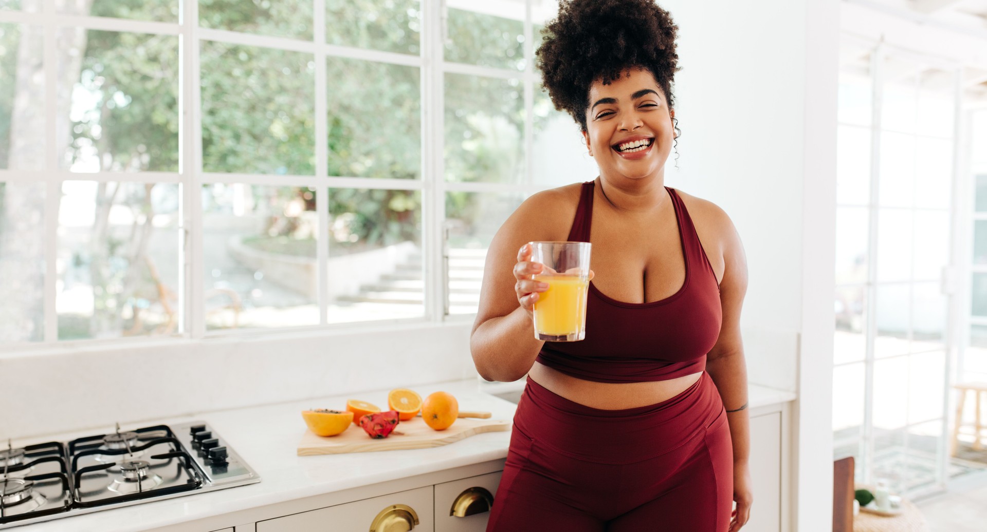 Fitness woman with glass of juice at home